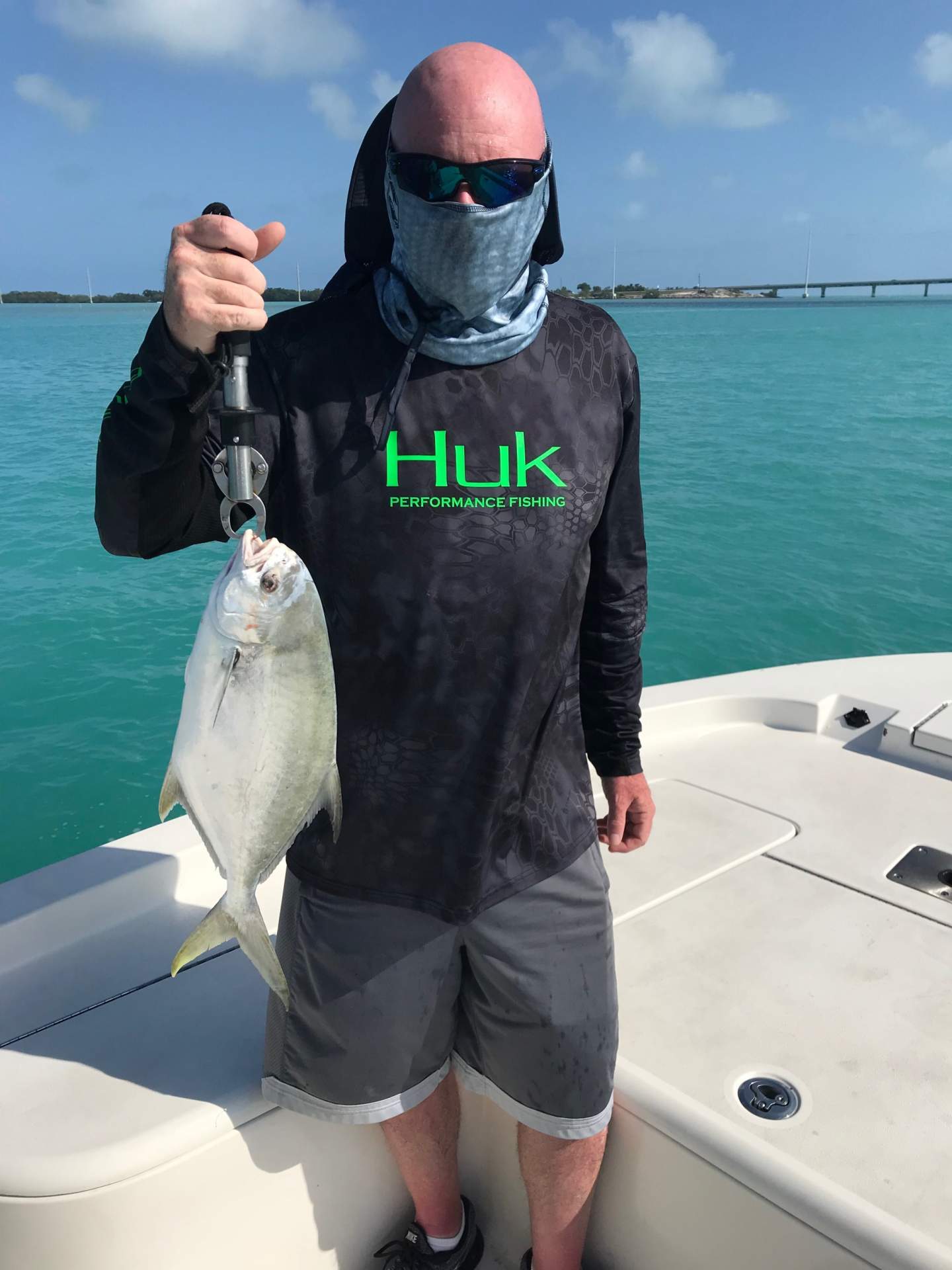 https://www.reelattackcharters.com/images/Man-wearing-black-hulk-fishing-shirt-holding-fish.JPEG?
