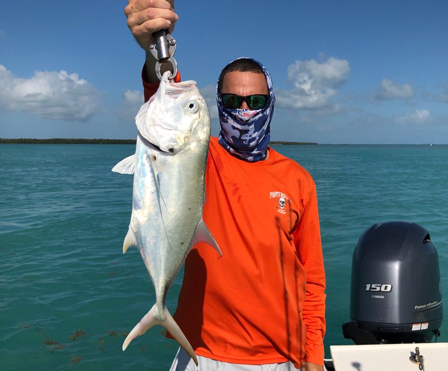 Captain Jon holding a Jack fish up