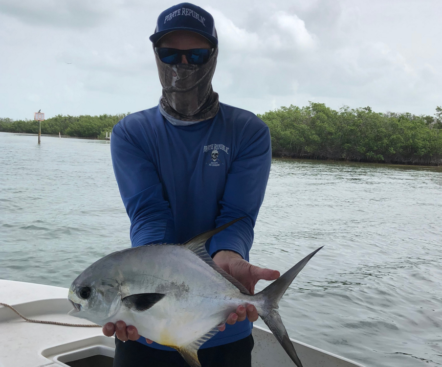 Captain Jon holding permit fish up