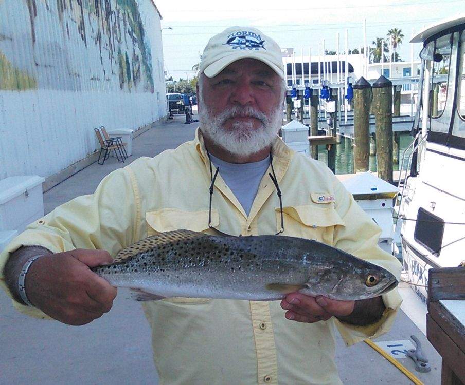 Man holding Trout caught from Backcountry