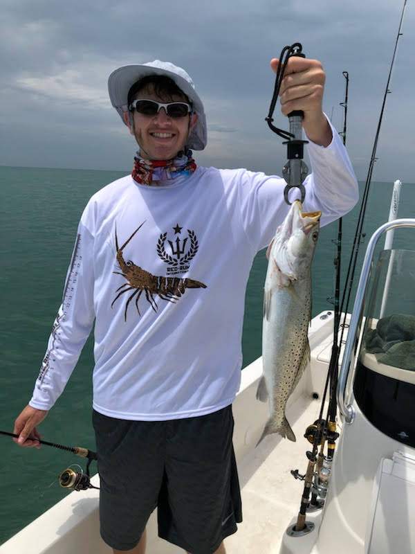 Man holding a speckled trout